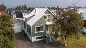 an aerial view of a green house with a garage at Akureyri apartments in Akureyri