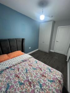 a bedroom with a bed with a colorful bedspread at Happy Place in Navan +2 photos