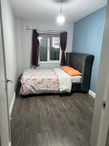 a bedroom with a bed and a window at Happy Place in Navan