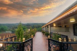 a balcony of a building with a walkway at Bagicha villa and cottage in Mahabaleshwar