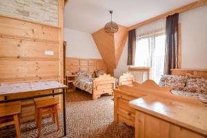 a living room with wooden furniture and a large window at U Gronikowskich in Zakopane +113 photos