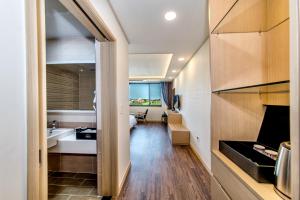 a bathroom with a tub and a sink in a room at Seawater Spa Hotel Coza in Seogwipo