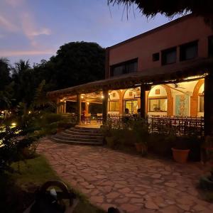 a building with a stone walkway in front of it at Badalodge in Bamako