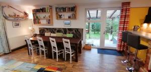 a dining room with a wooden table and chairs at Qvintesencia Terchová in Terchová