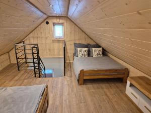 a bedroom with a bed and a staircase in a tiny house at VILLA-Harmony in Ustroń +17 photos