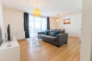 a living room with a couch and a television at Ferien & Business Apartments Hohenfels in Hohenfels +197 photos