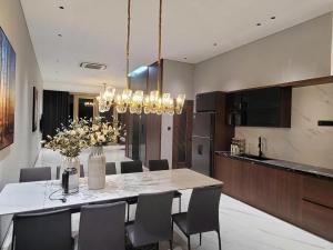 a kitchen and dining room with a table and chairs at Toàn Cầu Villa in Dương Cảnh