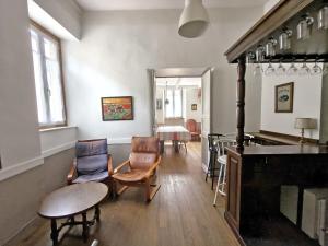 a living room with chairs and a table at Le Pitstop in Alan