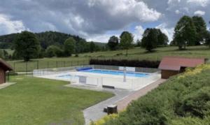 a swimming pool in the middle of a field at Refuge des pistes in Métabief