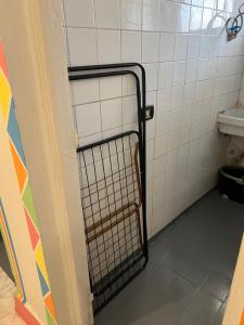 a bathroom with a gate in a bathroom stall at NubaNest GuestHouse in Aswan
