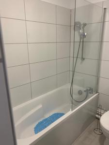 a bathroom with a shower and a tub with a toilet at Joli studio agréable neuf in Canet-en-Roussillon +13 photos