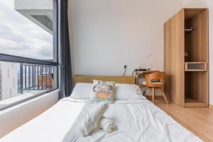 a bedroom with a bed and a large window at Aradia Lakecity with Totoro Muji Theme in Batu Caves Selayang, Kuala Lumpur by Nestaway in Kuala Lumpur +23 photos