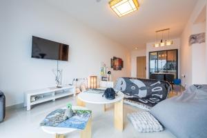 a living room with a couch and a table at Aradia Lakecity with Totoro Muji Theme in Batu Caves Selayang, Kuala Lumpur by Nestaway in Kuala Lumpur