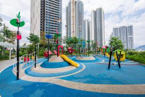 a playground in a city with buildings in the background at Aradia Lakecity with Totoro Muji Theme in Batu Caves Selayang, Kuala Lumpur by Nestaway in Kuala Lumpur