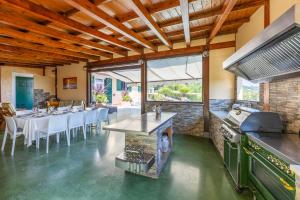 a kitchen and dining room with a table and a stove at Villa La Quiete in Mogliano