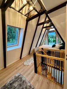 a room with a bed and a balcony in a house at Zago Alpin in Câmpulung Moldovenesc