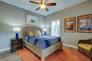 a bedroom with a bed and a ceiling fan at 307 Main Sail in Hilton Head Island +39 photos