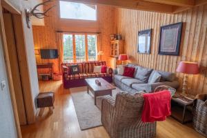 a living room with a couch and a table at Apartment Mélodie de Rêve in Crans-Montana