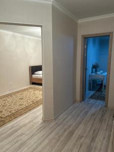 an empty room with a door leading to a bedroom at Посуточно квартира in Aktobe