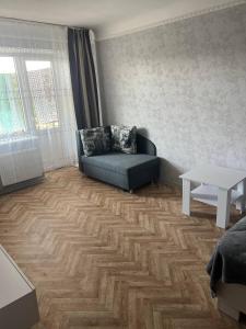 a living room with a couch and a table at Apartment shop 44 in Korostenʼ