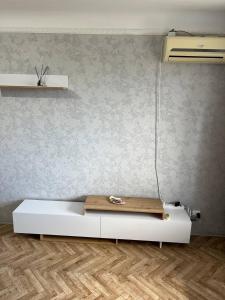 a bed in a room with a wall at Apartment shop 44 in Korostenʼ