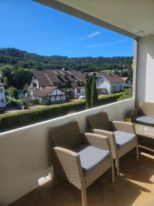 a balcony with chairs and a view of a town at Premium Home 1 in Busingen am Hochrhein