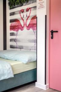 a room with two flamingos painted on the wall at Vice City Hostel District 2 in Wrocław