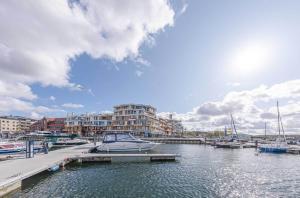 a marina with boats in the water and buildings at Sieglinde - Apartment in der Hafenresidenz mit Balkon & Wellness in Waren +13 photos