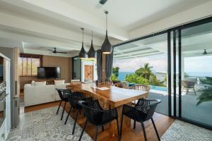 an open kitchen and dining room with a table and chairs at Tahiana Villa in Haad Tian