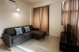 a living room with a couch and a television at Arrival View in Male City +1 photo