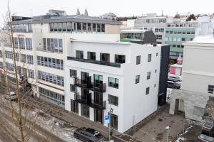 an aerial view of a white building in a city at New apartment downtown Akureyri in Akureyri