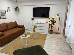 a living room with a couch and a flat screen tv at M B Homes Lauterstein 8 in Weißenstein