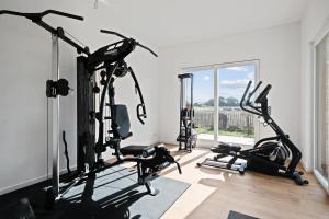 a gym with two treadmills and two ellipticals at Alte Schule Westerhever Porrendeich in Westerhever