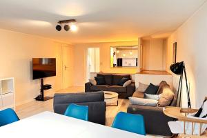a living room with two couches and a tv at Spacieuse Maison rénovée 6 personnes in Vandoeuvre-lès-Nancy +10 photos