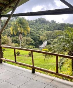 a balcony with a view of a lush green hillside at OYO Hotel Rincón Texolo in Xico