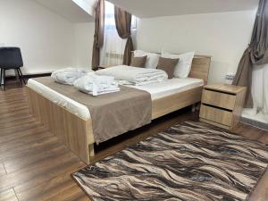 a bedroom with a bed with white sheets and a rug at Belon Garden Hotel in Prigorodnyy +24 photos