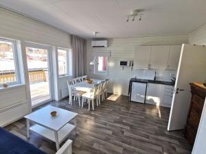 a kitchen and dining room with a table and chairs at Färjas Brygga in Söråker
