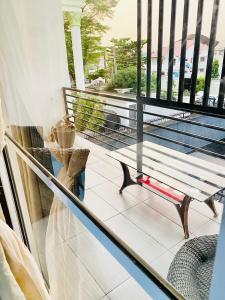 a glass railing on a balcony with a bench at 3Apartments in Lagos