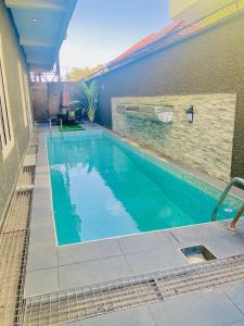 a swimming pool next to a building at 3Apartments in Lagos