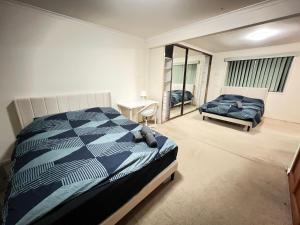 a bedroom with a bed and a mirror in it at Family Room in Two Story Home - R9 in Sydney