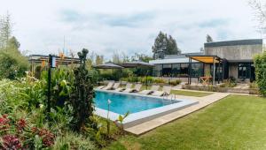 a backyard with a swimming pool and a house at Amarembo by Touch Down in Kigali