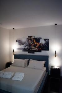 a bedroom with a bed with two pictures on the wall at Crystal Luxury Apartment in Capurso +36 photos