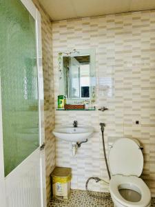 a bathroom with a toilet and a sink at Tuệ Tĩnh Tower in Nha Trang