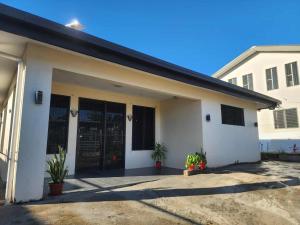 a white house with plants in front of it at Lautoka Home away from Home in Lautoka