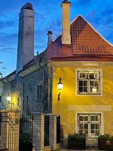 a yellow house with a light on the side of it at Bishop's Residence in Tallinn