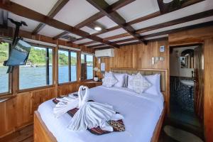 a bedroom with a bed in a boat at Boat Komodo in Seminyak