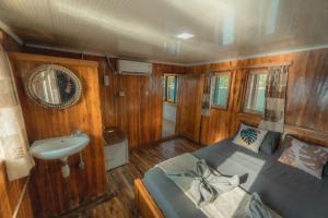 a small room with a bed and a sink at Boat Komodo in Seminyak +32 photos