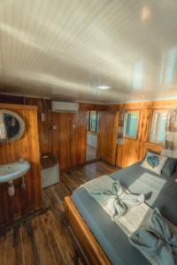 a bedroom of a boat with a bed and a sink at Boat Komodo in Seminyak