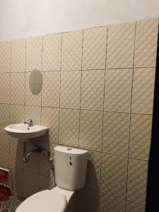 a bathroom with a toilet and a sink at Raya Homestay in Kuta Lombok +20 photos