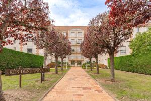 a building with a brick pathway in front of a building at Bright Studio 3P – Close to Deauville Beach in Deauville